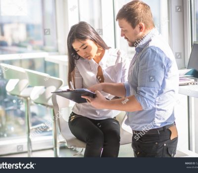 stock-photo-businessman-showing-his-colleague-businesswoman-prices-on-paper-while-working-in-office-interior-526146091
